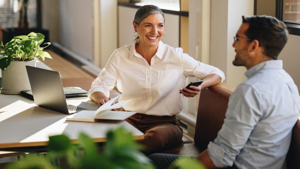 Woman smiling at co-worker